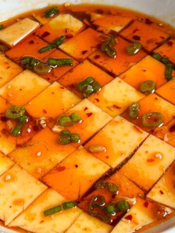 microwaved steamed eggs cut into squares topped with scallions, chili oil, sesame oil and soy sauce.