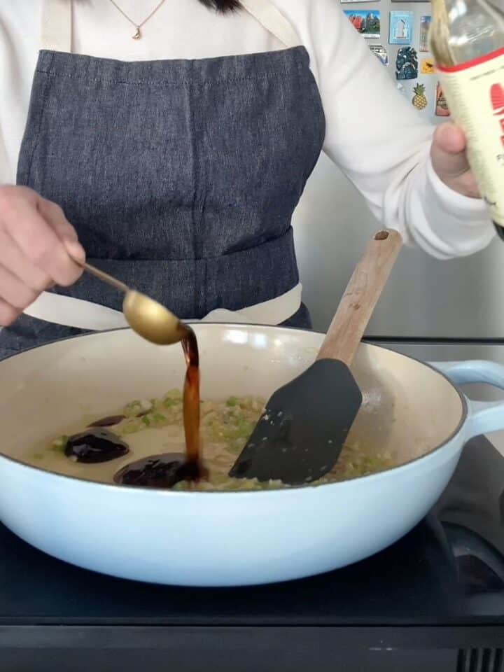 Pouring fish sauce into the pan with garlic and butter. 