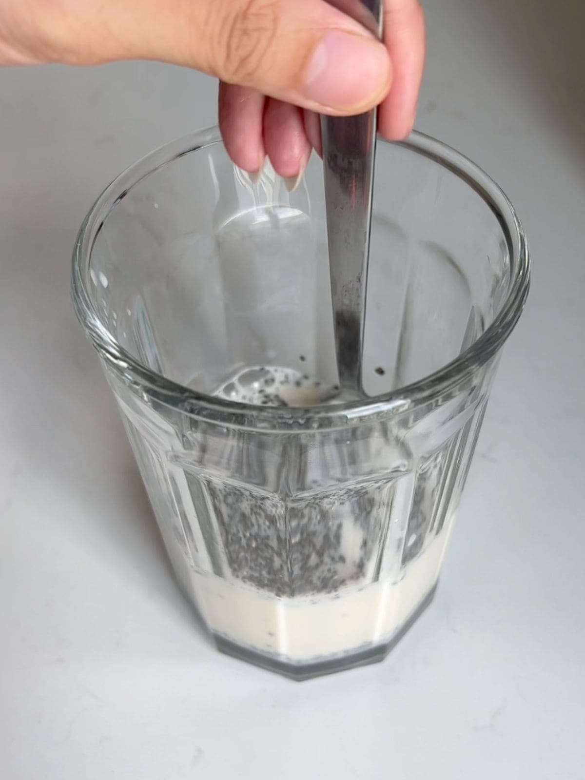 Stirring chia seeds with plant based milk.