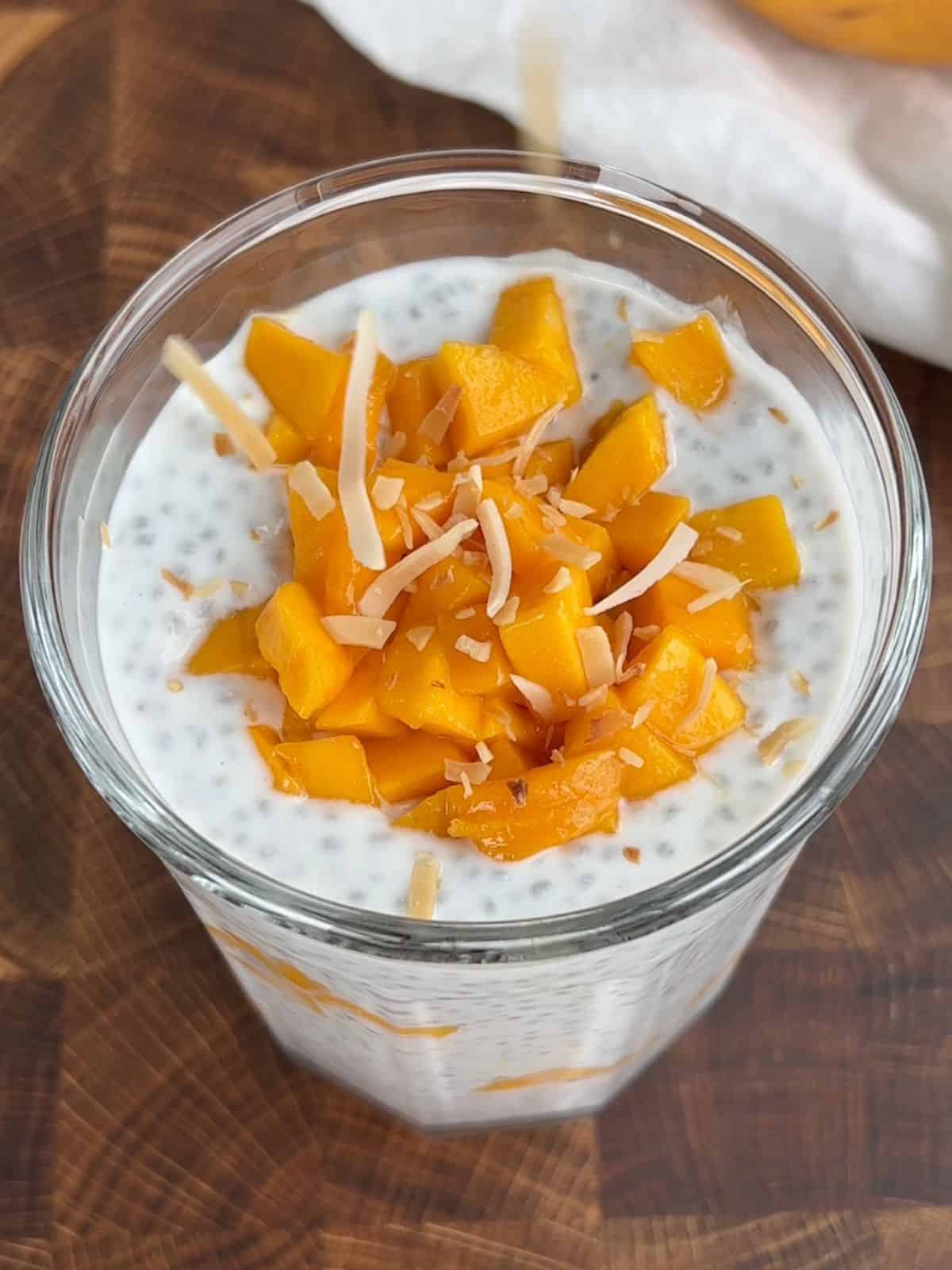 Sprinkling coconut on top of the chia mango pudding.