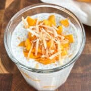 Mango chia pudding topped with diced mango and toasted coconut flakes.