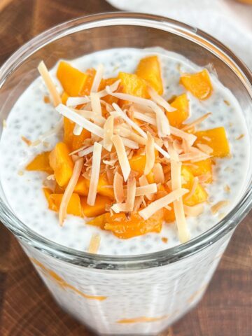 Mango chia pudding topped with diced mango and toasted coconut flakes.