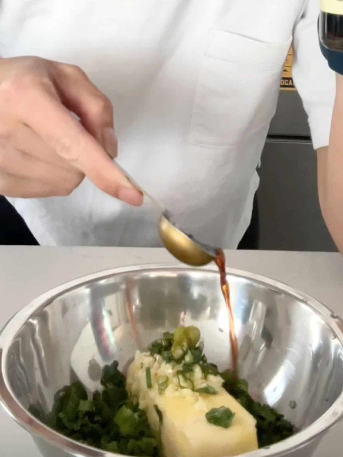 Making fish sauce butter in a mixing bowl.