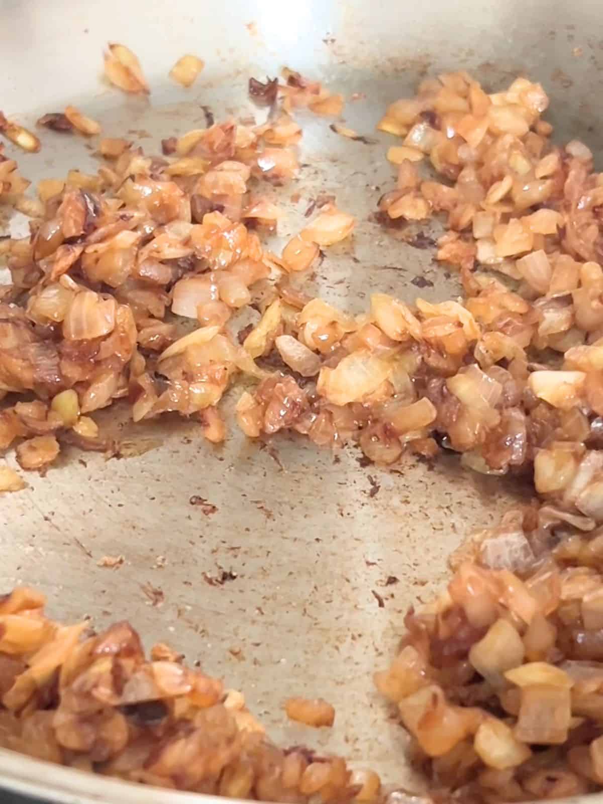 Diced caramelized onions in a pan.