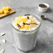 Pina colada chia pudding topped with fresh pineapple and coconut flakes.