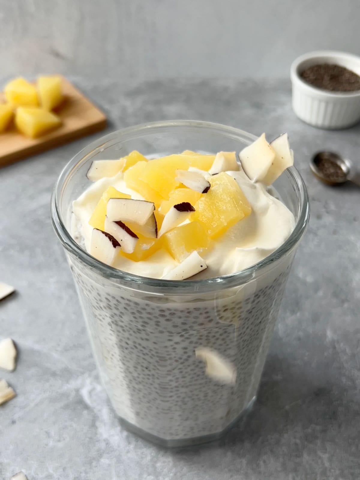 Sprinkling coconut flakes onto the pina colada chia pudding before serving.