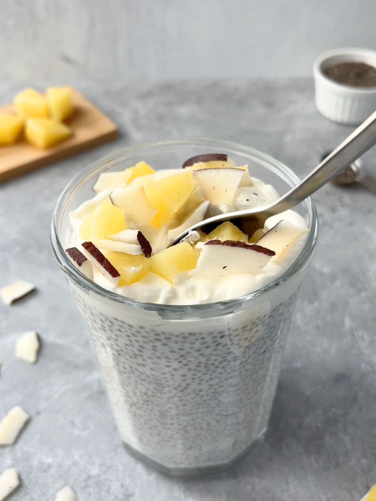 Spoon dipping into the piña colada chia pudding.